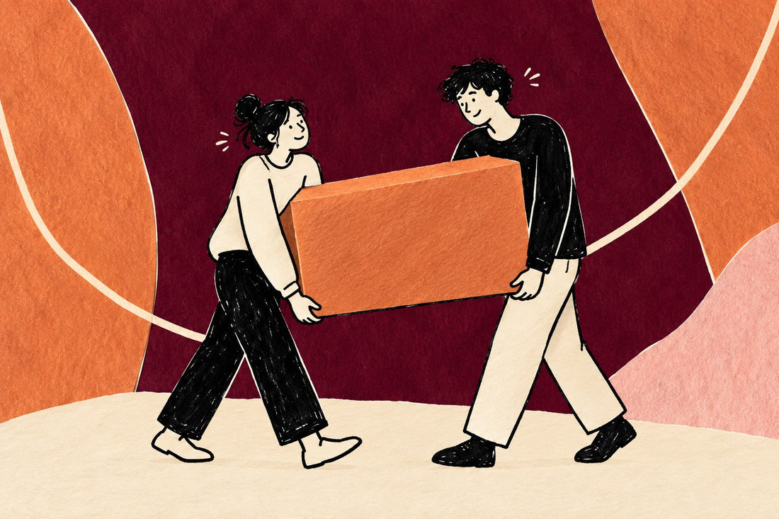 Hand-drawn illustration of two tired people carrying one heavy box together and sharing a small smile